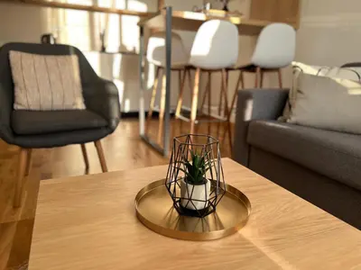 a small plant in a glass bowl on a table at Prirodni Raj-Udoban Sokobanja Apartman in Soko Banja