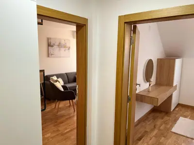 a door leading into a room with a living room at Prirodni Raj-Udoban Sokobanja Apartman in Soko Banja