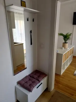 a small room with a mirror and a stool at Studio SIESTA in Vrnjačka Banja