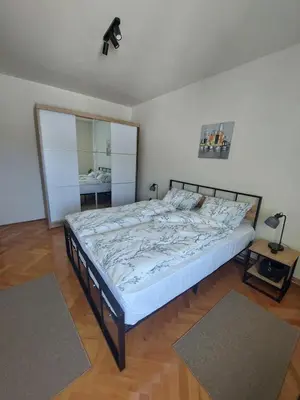 a bedroom with a large bed with white sheets at Balkan HOME in Kalna