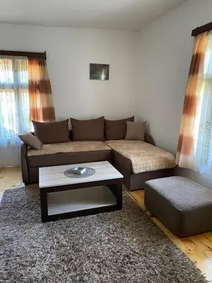 a living room with a couch and a coffee table at Apartmani Nikola Dojkinci in Pirot