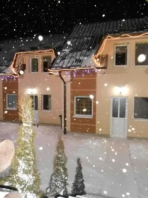 a house covered in snow at night at Apartments Villa Stars in Kopaonik