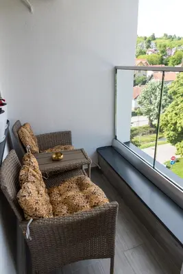 a room with two chairs and a large window at Apartmani Central 14 & Free parking garage in Vrnjačka Banja