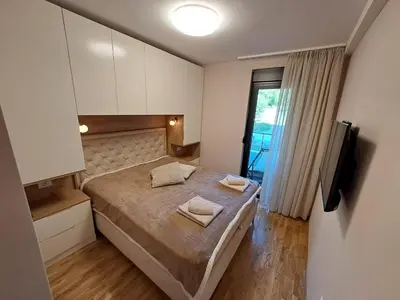 a bedroom with a bed with two towels on it at Hakuna Matata in Vrnjačka Banja