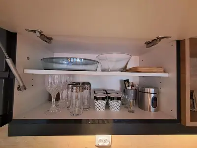 a shelf with a bunch of glass items on it at Hakuna Matata in Vrnjačka Banja