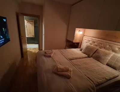 a bedroom with a large bed in a room at Hakuna Matata in Vrnjačka Banja