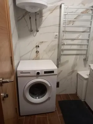 a washing machine in a bathroom with a sink at Hakuna Matata in Vrnjačka Banja