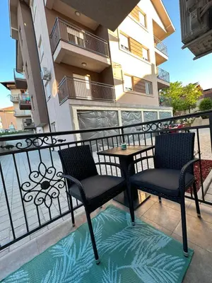 a balcony with two chairs and a table at Talija apartman 3 in Vrnjačka Banja
