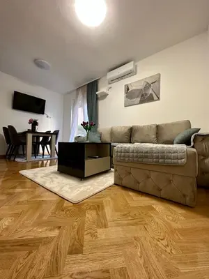 a living room with a couch and a table at Talija apartman 3 in Vrnjačka Banja