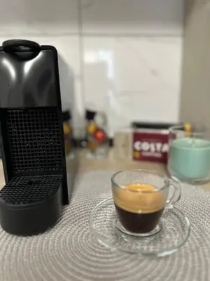 a cup of coffee next to a laptop on a table at Talija apartman 3 in Vrnjačka Banja