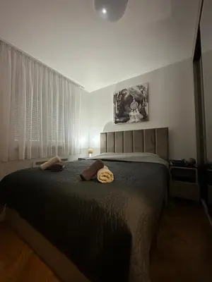 a bedroom with a bed with two towels on it at Talija apartman 3 in Vrnjačka Banja