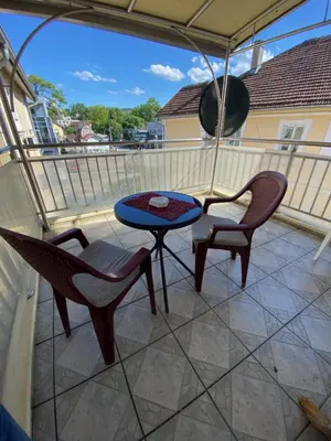 a patio with two chairs and a table on a balcony at Vila Nada Apartment in Vrnjacka Banja in Vrnjačka Banja