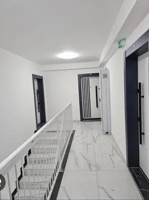 a hallway with white walls and a stair case at Apartman Daria in Vrnjačka Banja