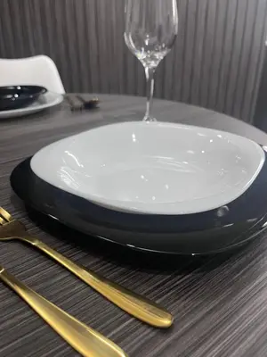 a plate and a wine glass on a table at Apartman Daria in Vrnjačka Banja