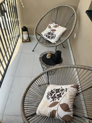 a balcony with two chairs and a pillow and a table at Lenka Lux VB in Vrnjačka Banja