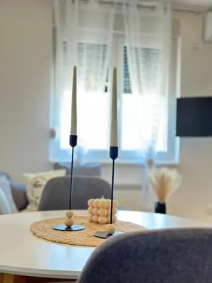 a table with two candles on top of it at Lenka Lux VB in Vrnjačka Banja
