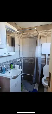 a bathroom with a sink and a toilet and a mirror at Tosic etno kamp in Pirot