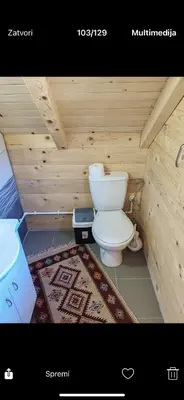 a small bathroom with a toilet and a sink at Tosic etno kamp in Pirot