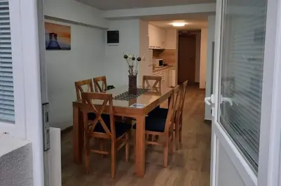 a dining room with a wooden table and chairs at Apartman Djukic Sokobanja 1 in Soko Banja