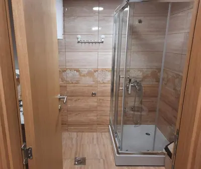 a shower with a glass door in a bathroom at Apartman Djukic Sokobanja 1 in Soko Banja