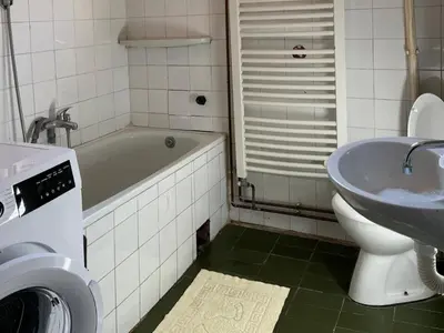 a bathroom with a tub and a sink and a toilet at Milovanović in Kuršumlija