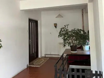 a room with a table and a potted plant at Milovanović in Kuršumlija