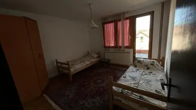 a bedroom with two beds and a window at Milovanović in Kuršumlija