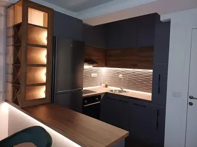 a kitchen with black cabinets and a black refrigerator at Mila apartman in Prokuplje