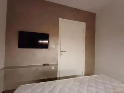 a bedroom with a bed and a flat screen tv on the wall at Mila apartman in Prokuplje