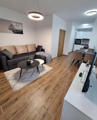 a living room with a couch and a table at Apartman WIN Sokobanja in Soko Banja