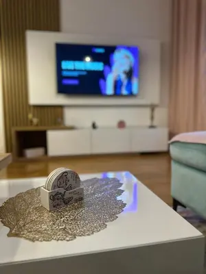a living room with a table with a box on it at Violet deluxe in Niš