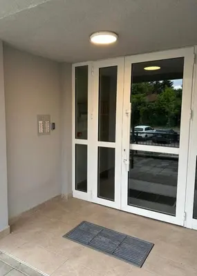 an empty room with sliding glass doors in a house at Violet deluxe in Niš