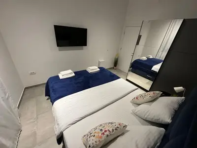 a hotel room with two beds and a mirror at Mint House in Niš