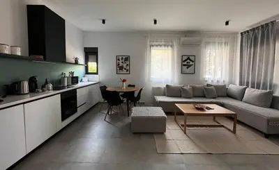 a living room with a couch and a table at Mint House in Niš