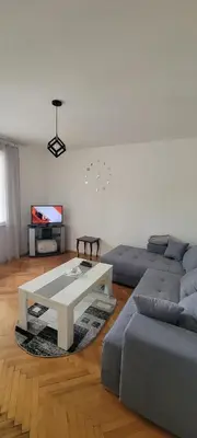 a living room with a couch and a coffee table at Apartman Kraljevo-ceo stan,privatan parking in Kraljevo