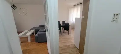 a living room with a couch and a table at Apartman Kraljevo-ceo stan,privatan parking in Kraljevo