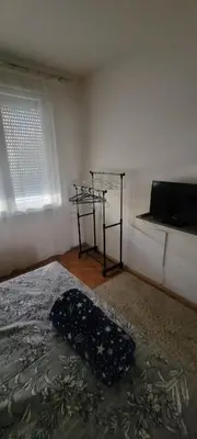 a bedroom with a bed and a window at Apartman Kraljevo-ceo stan,privatan parking in Kraljevo