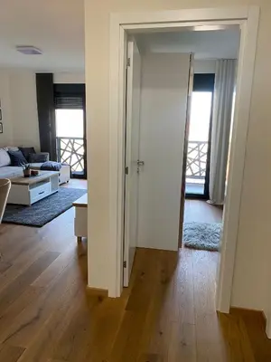 a living room with a couch and a room with a door at Hakuna Matata 2 in Vrnjačka Banja