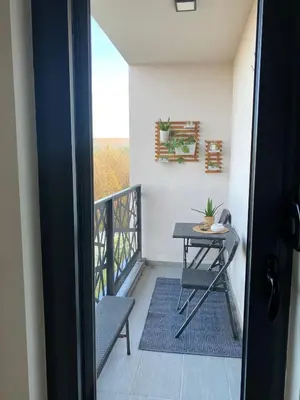 a small balcony with a table and a table at Hakuna Matata 2 in Vrnjačka Banja