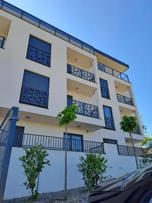 a building with balconies and trees in front of it at Hakuna Matata 2 in Vrnjačka Banja
