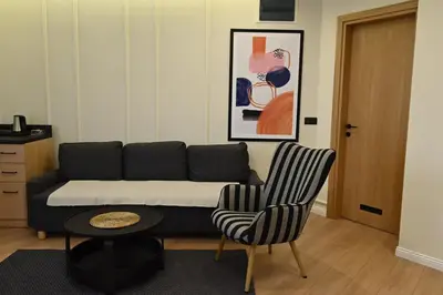 a living room with a couch and two chairs at Paradiso in Leskovac