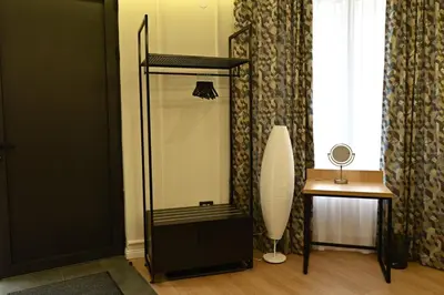 a mirror in a room with a table and a window at Paradiso in Leskovac