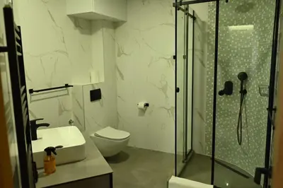 a bathroom with a shower and a toilet and a sink at Paradiso in Leskovac