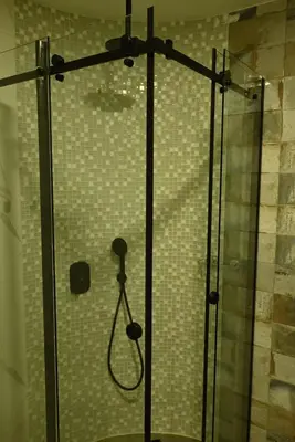 a shower with a glass door with a shower head at Paradiso in Leskovac