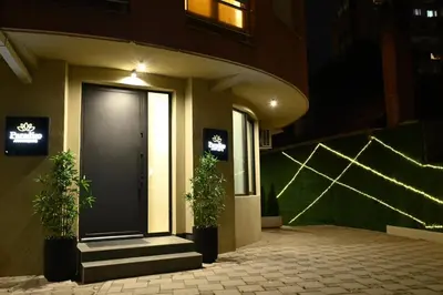 a front door of a building with two plants at Paradiso in Leskovac