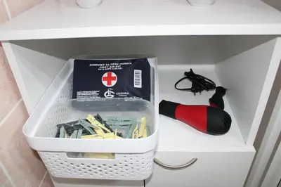 a drawer with a box of tools in a refrigerator at Apartman Lorenzo in Vrnjačka Banja
