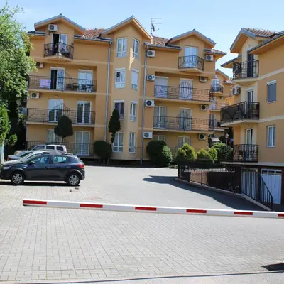 a car parked in a parking lot in front of a building at Apartman Lorenzo in Vrnjačka Banja