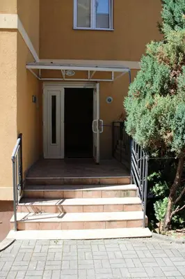 a set of stairs leading to a building with a door at Apartman Lorenzo in Vrnjačka Banja