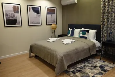 a bedroom with a bed with towels on it at Paradiso 2 in Leskovac