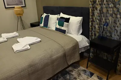 a bedroom with a large bed with towels on it at Paradiso 2 in Leskovac